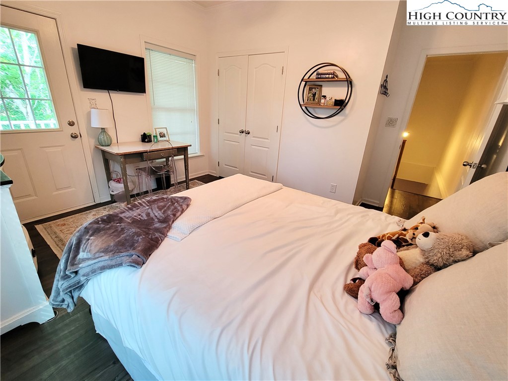 107 Stratford Lane, Unit 24B Boone, NC 28607 - Photo 25 of 45 a bedroom with a bed and a flat screen tv
