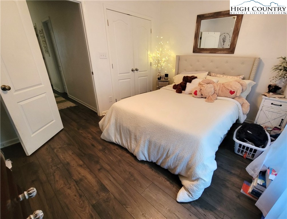 107 Stratford Lane, Unit 24B Boone, NC 28607 - Photo 26 of 45 a bedroom with a bed and wooden floor