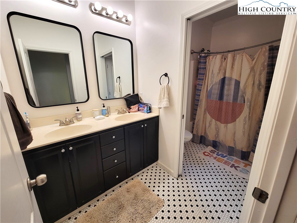 107 Stratford Lane, Unit 24B Boone, NC 28607 - Photo 35 of 45 a bathroom with a double vanity sink and mirror