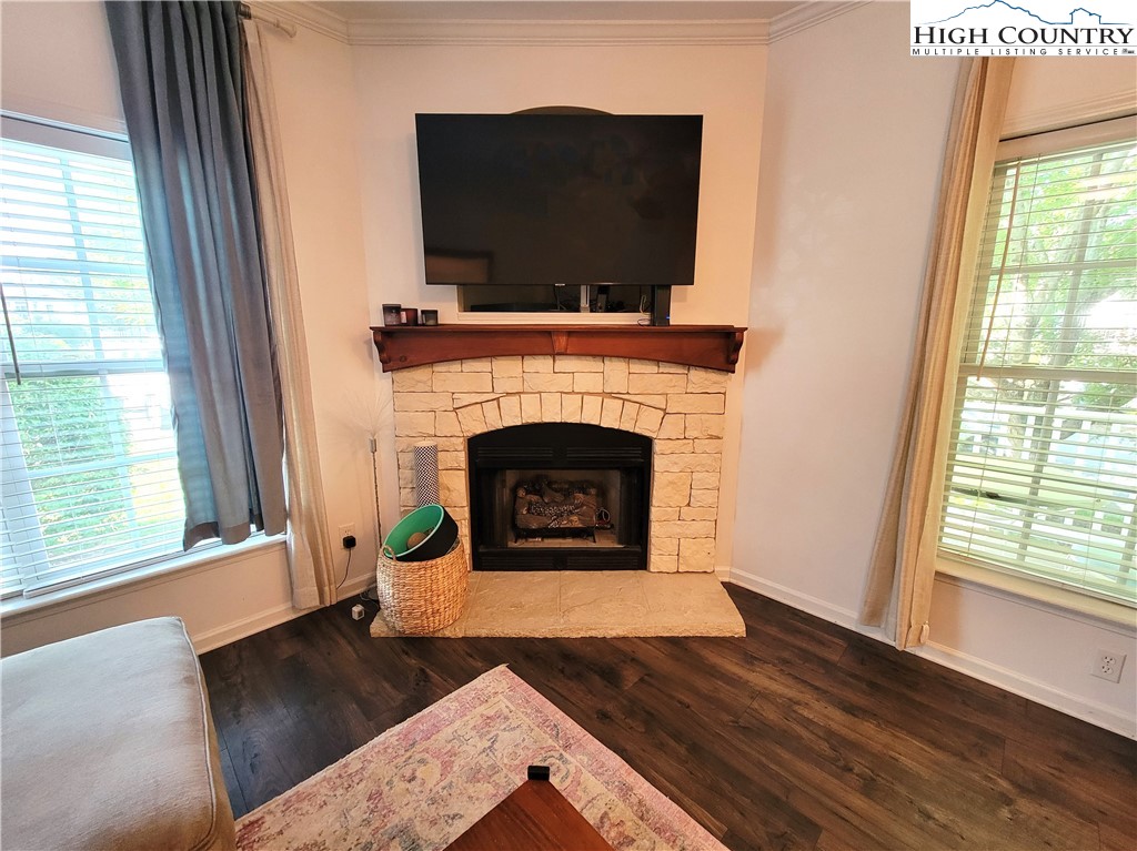 107 Stratford Lane, Unit 24B Boone, NC 28607 - Photo 10 of 45 a living room with a fireplace and a flat screen tv