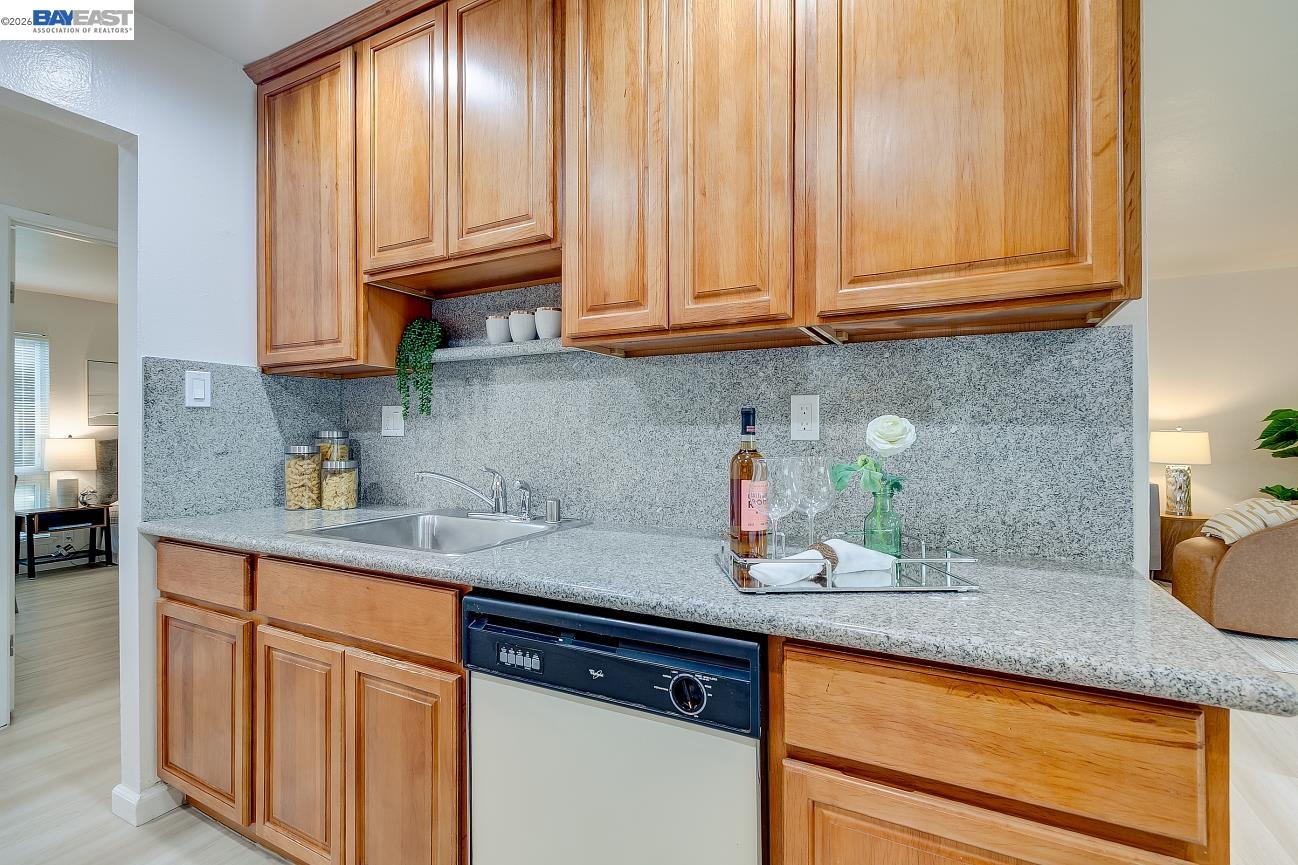 9005 Alcosta Boulevard, Unit 199 San Ramon, CA 94583 - Photo 30 of 57 a kitchen with granite countertop stainless steel appliances sink microwave and stove