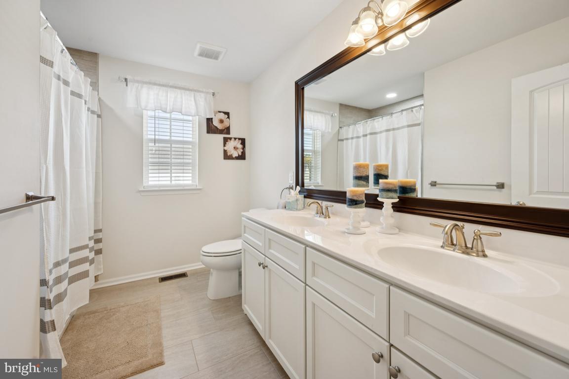 30 Champlain Road Marlton, NJ 08053 - Photo 24 of 30 a bathroom with a double vanity sink a toilet and a mirror