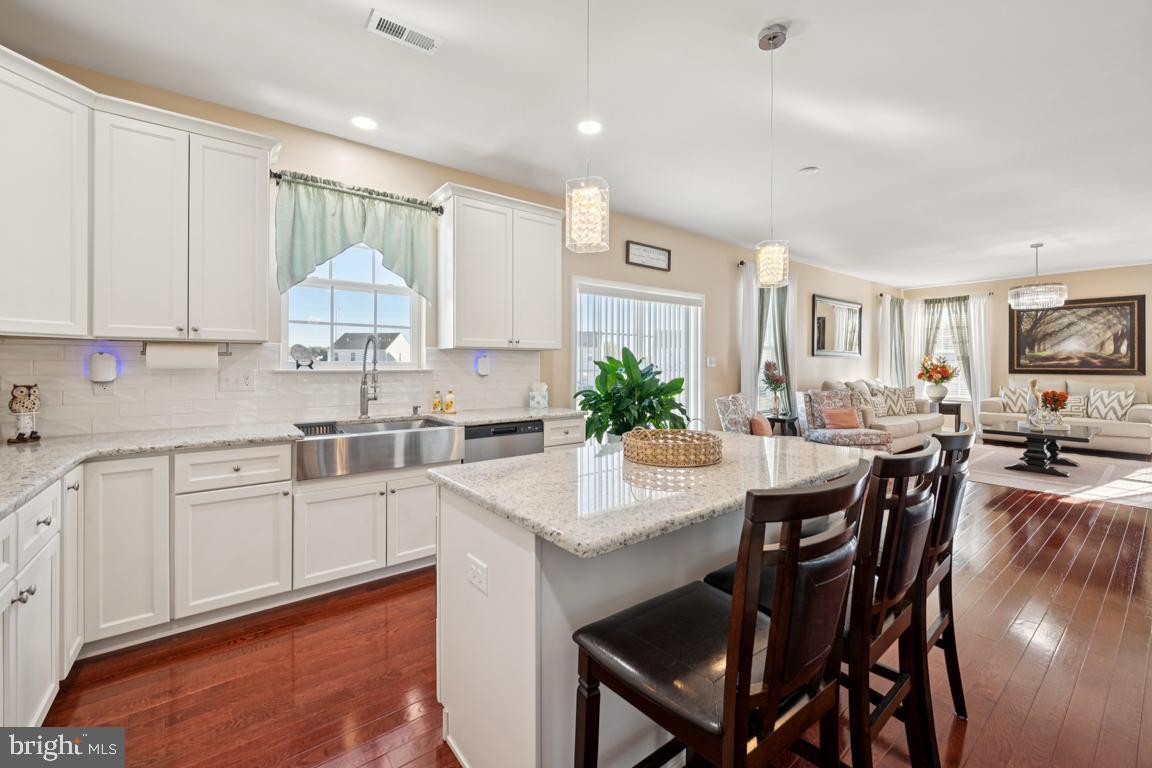 30 Champlain Road Marlton, NJ 08053 - Photo 9 of 30 a kitchen with stainless steel appliances granite countertop a table chairs sink and cabinets