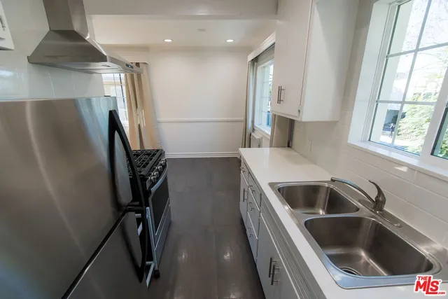 a kitchen with a refrigerator and a sink