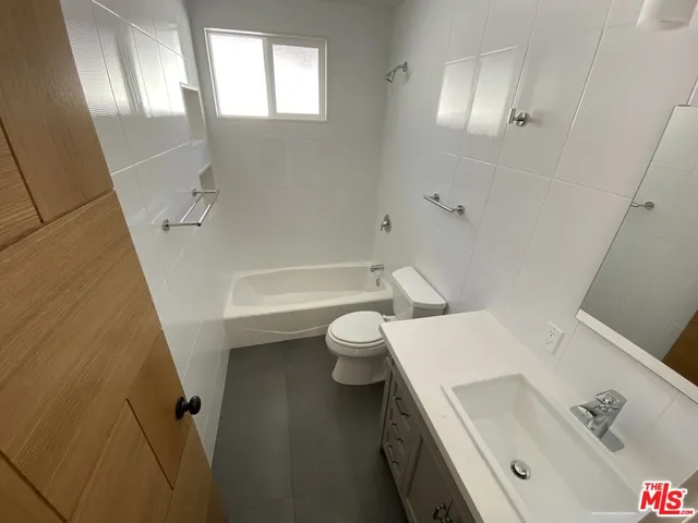 a bathroom with a sink a toilet and a bathtub