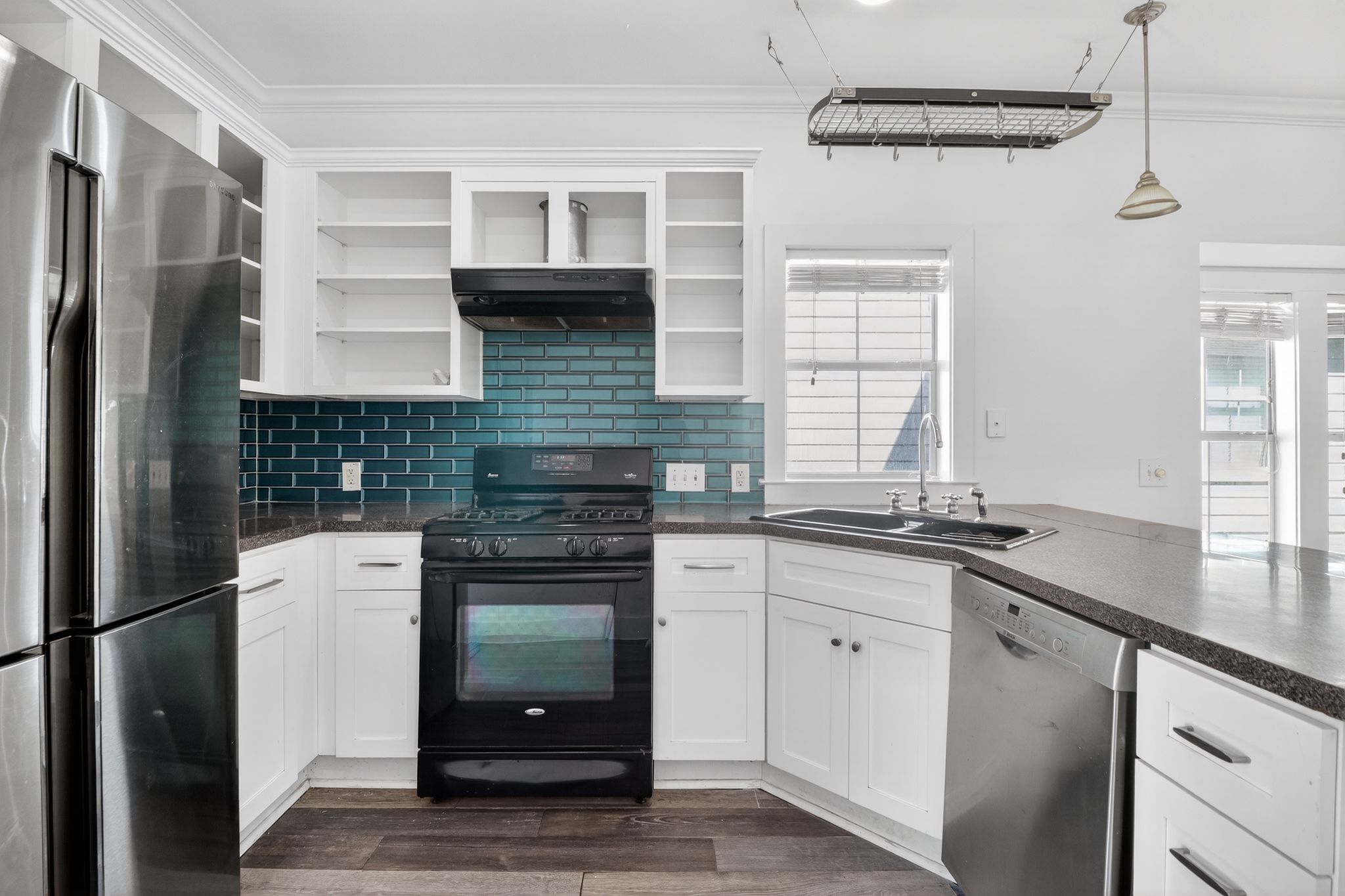 3614 South 2nd Street Austin, TX 78704 - Photo 15 of 40 a kitchen with granite countertop a refrigerator a sink a stove and cabinets