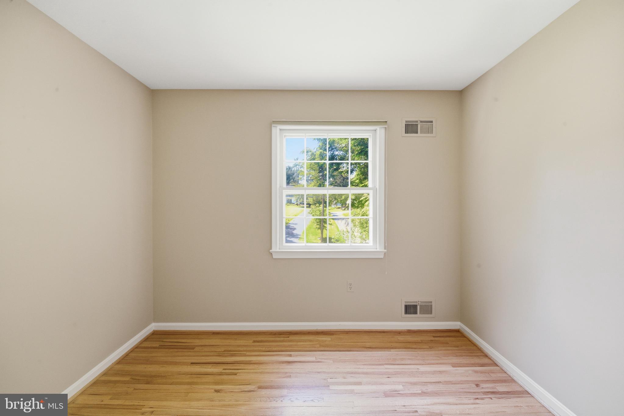 13309 Old Forge Road Silver Spring, MD 20904 - Photo 36 of 52 an empty room with wooden floor and windows