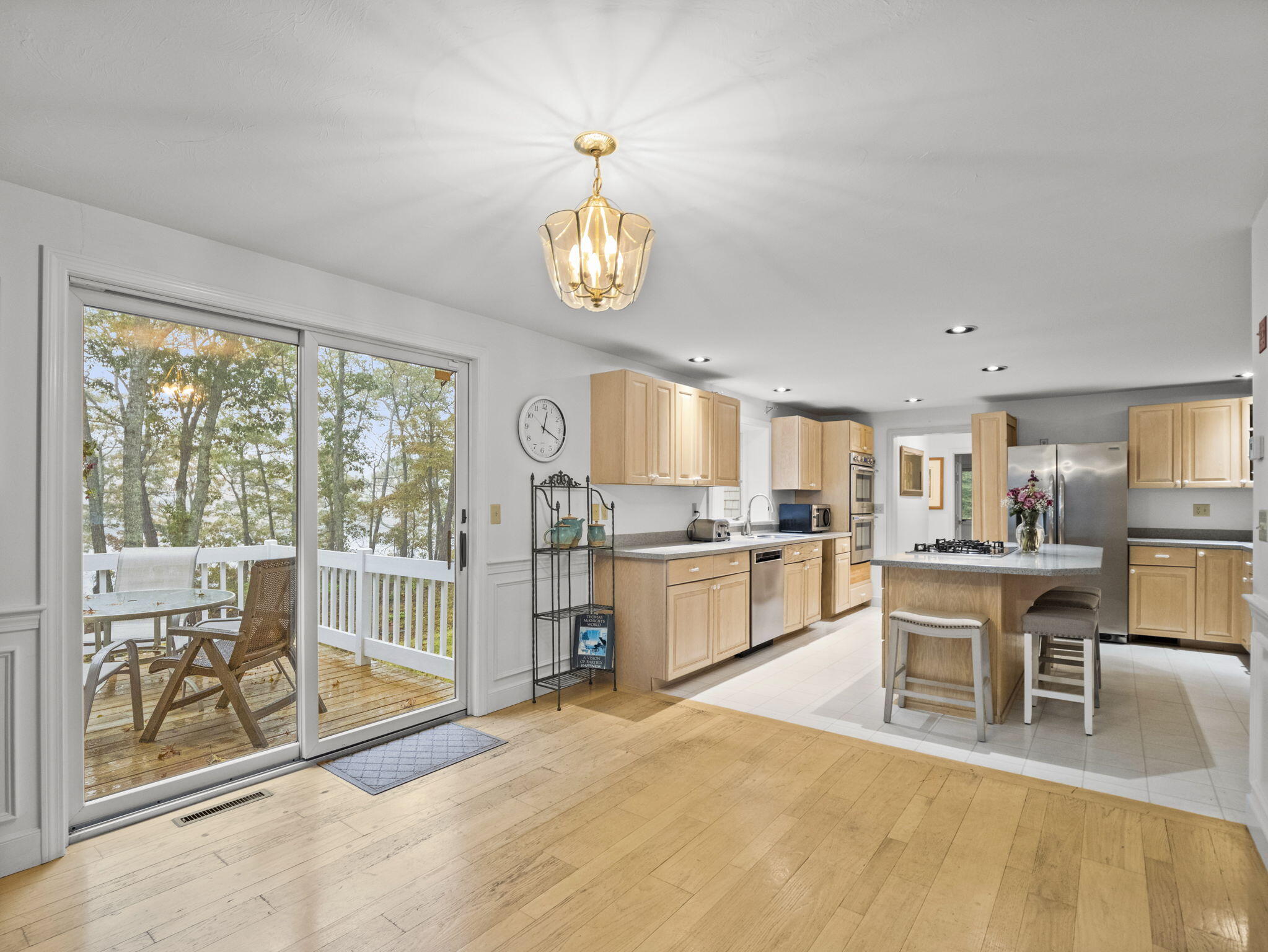 15 Goldie Way Barnstable, MA 02601 - Photo 19 of 48 a view of a dining room with furniture a chandelier and a large window