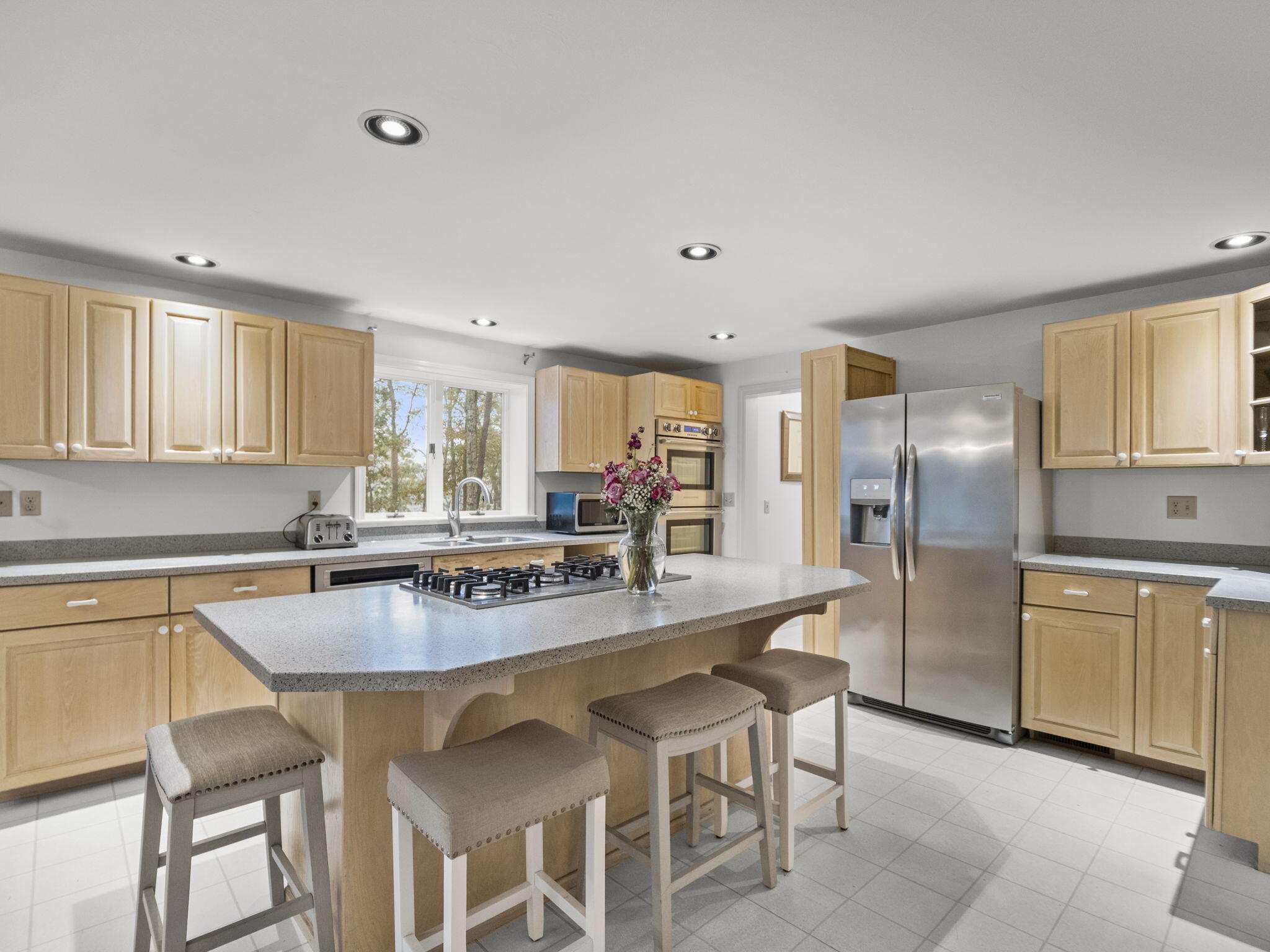 15 Goldie Way Barnstable, MA 02601 - Photo 22 of 48 a kitchen with stainless steel appliances granite countertop a stove a sink dishwasher and a refrigerator with wooden floor