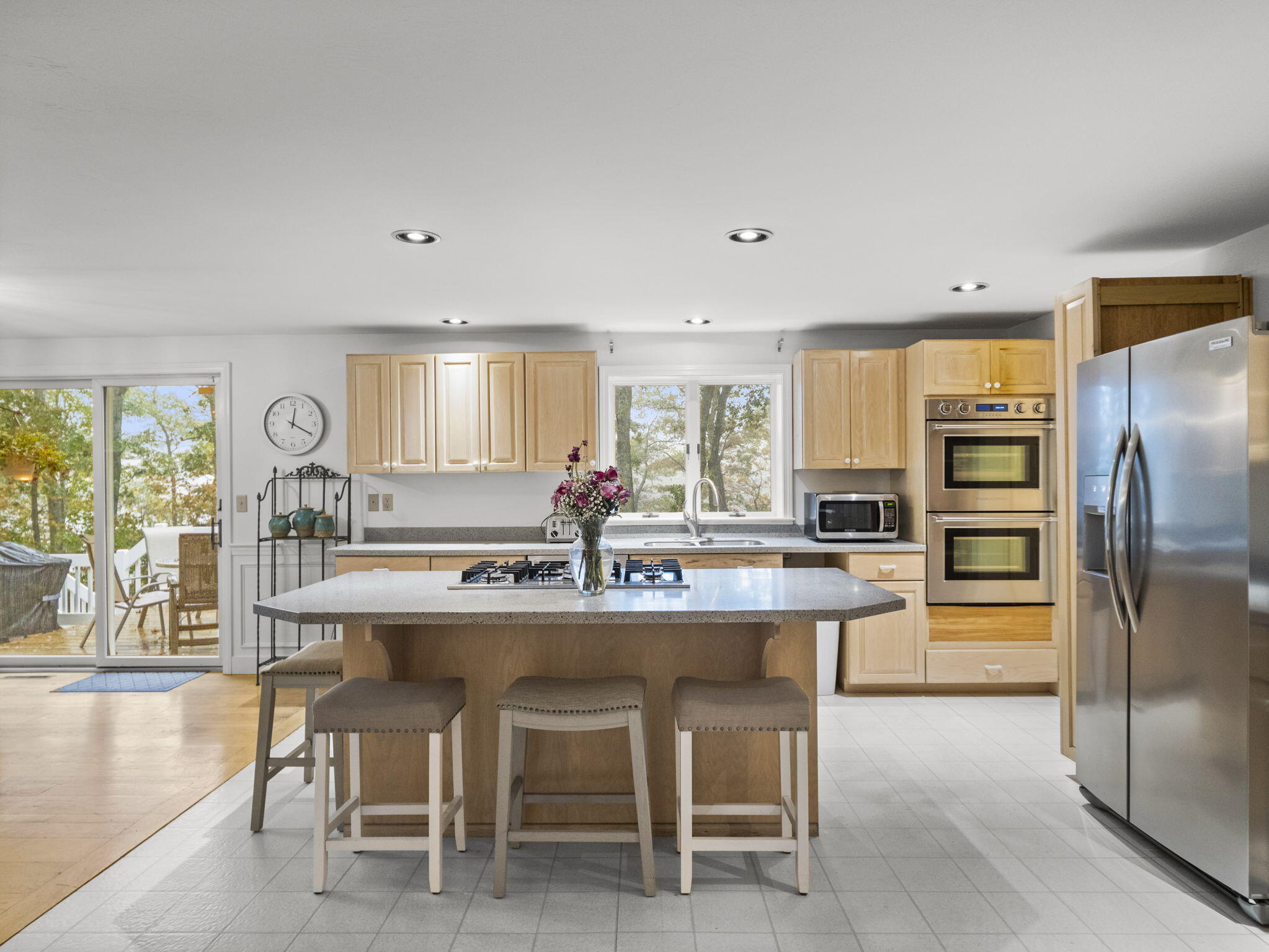 15 Goldie Way Barnstable, MA 02601 - Photo 23 of 48 a kitchen with a dining table chairs refrigerator and cabinets