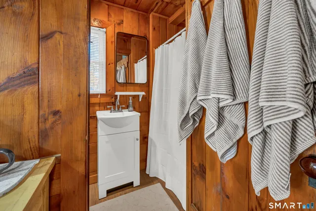 a bathroom with a sink a mirror and shower