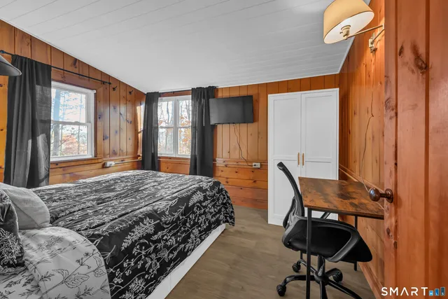 a bedroom with a bed and a desk