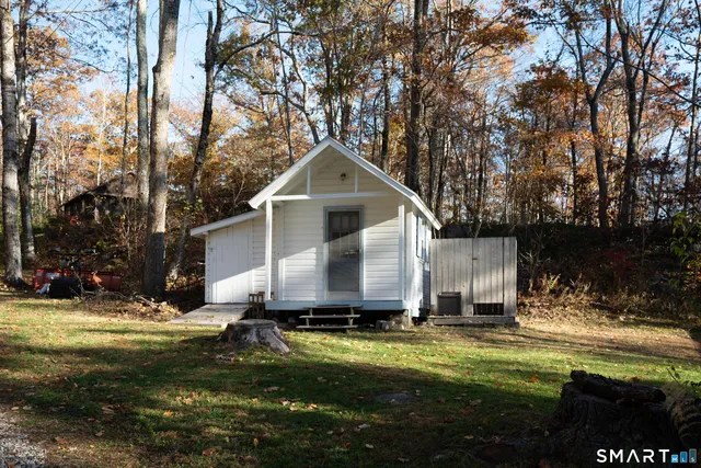 a view of a house with a yard covered with snow in front of house