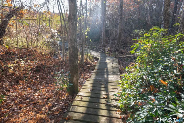a view of balcony with wooden floor and fence