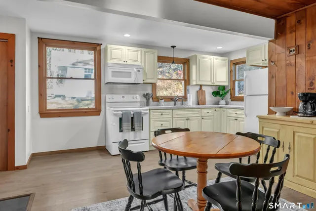 a view of a dining room with furniture and a window