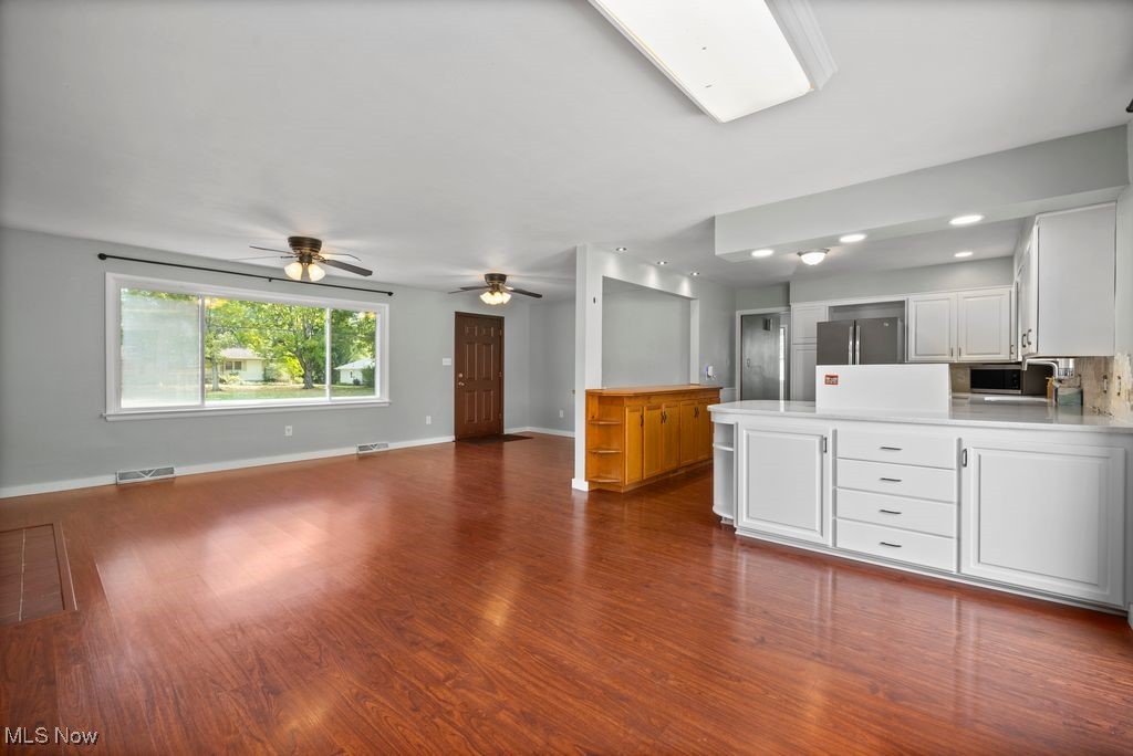 5956 Ryan Road Medina, OH 44256 - Photo 27 of 27 Kitchen featuring white cabinetry, a peninsula, light countertops, open floor plan, and dark wood-type flooring