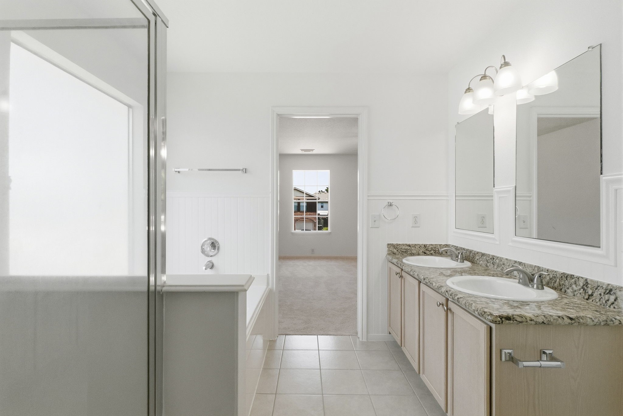 11907 Ezekiel Road Tomball, TX 77375 - Photo 29 of 39 a bathroom with a granite countertop sink and a mirror