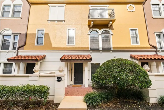 a front view of a building with a garden