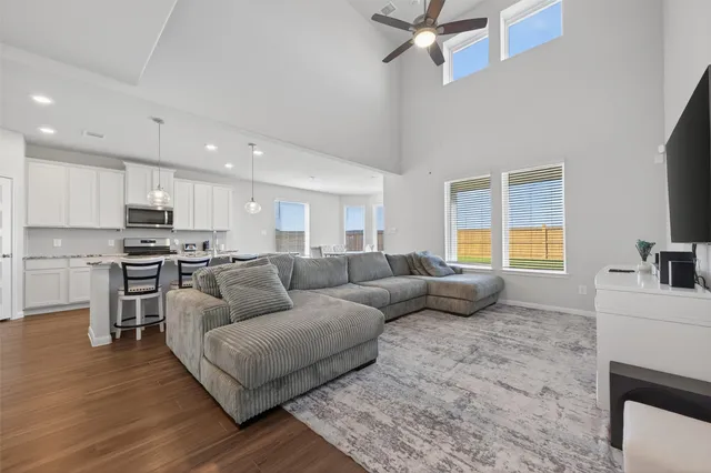 a living room with furniture and kitchen view