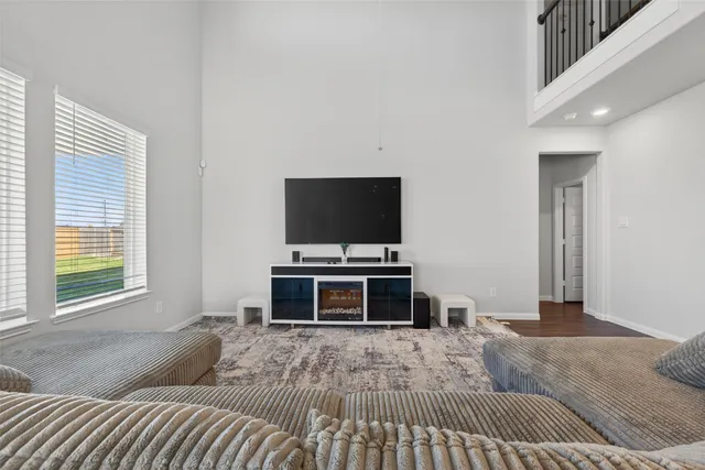 a living room with a flat screen tv and a fireplace