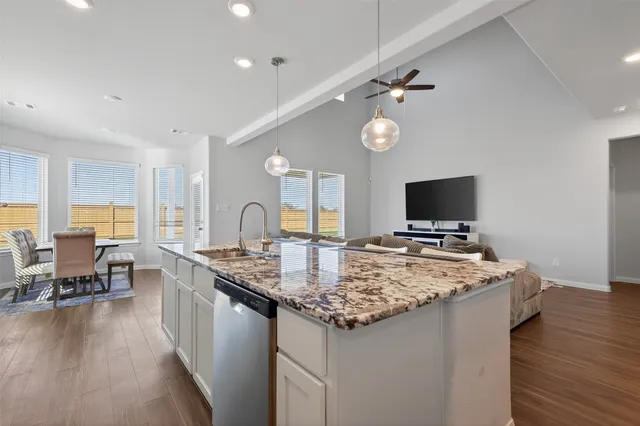a kitchen with sink stove and center island