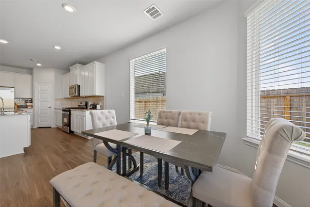 a view of a dining room with furniture window and wooden floor