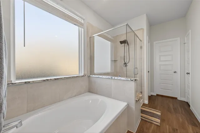 a bathroom with a bathtub and a shower