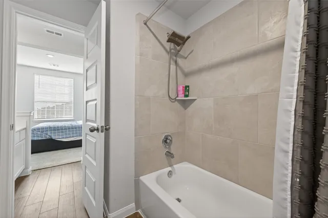 a bathroom with a tub and a shower