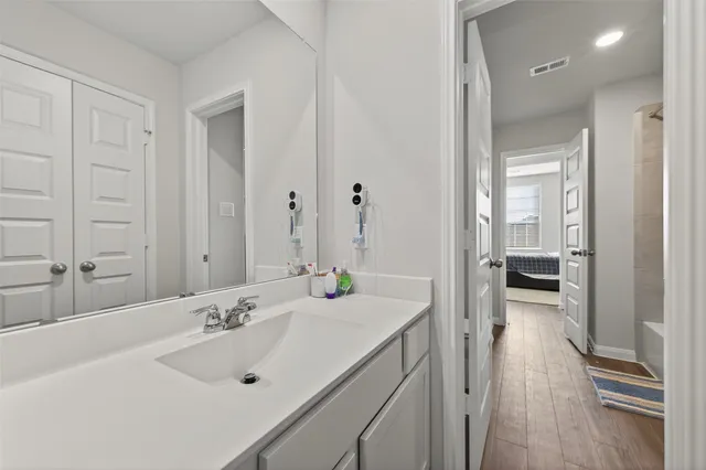 a en suite bathroom with a sink and a mirror
