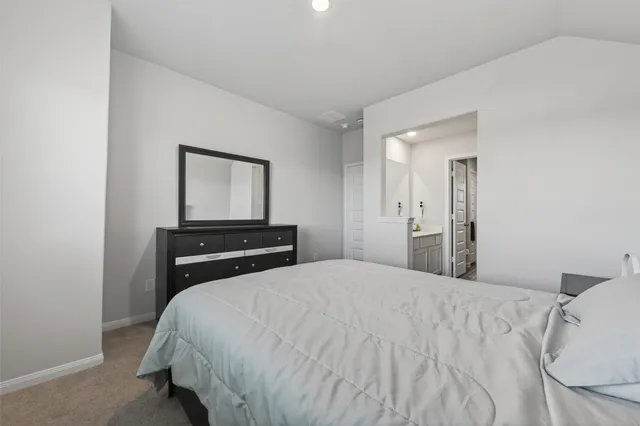 a bedroom with a bed and a night stand