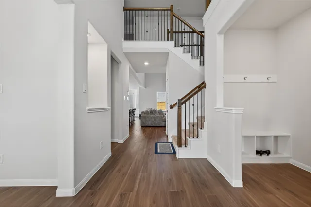 a view of entryway and hall with wooden floor