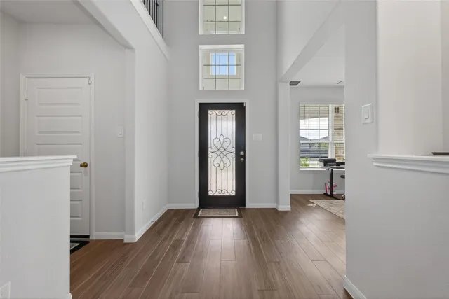 an empty room with wooden floor and a window