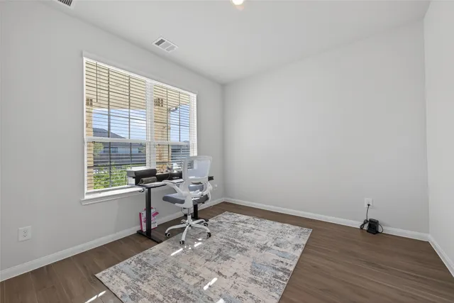 a bench sitting in a room next to a window