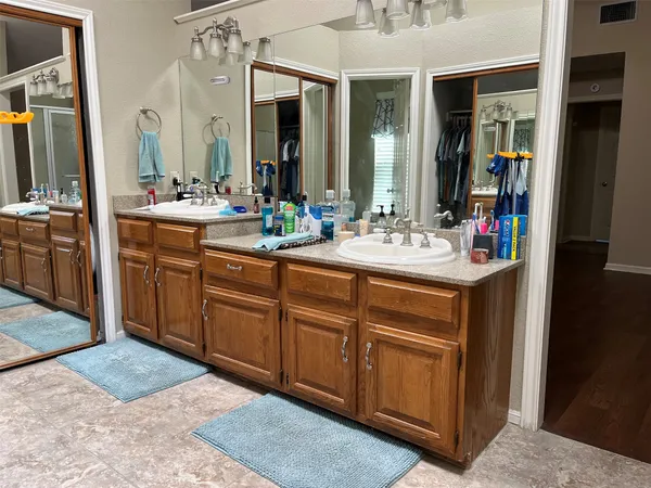 a bathroom with a sink vanity and mirror