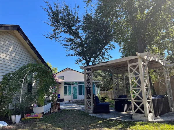 a view of a patio with table and chairs and potted plants