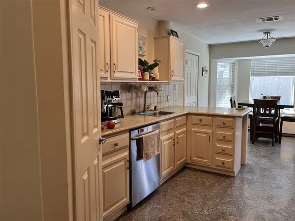 a kitchen with white cabinets and white appliances