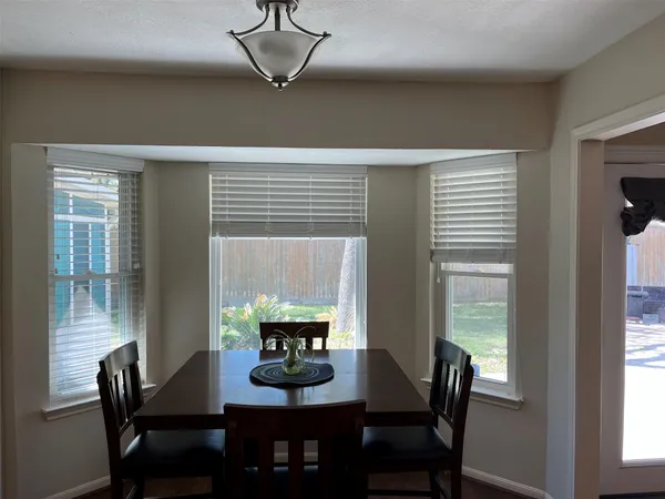 a view of a dining room with furniture and window