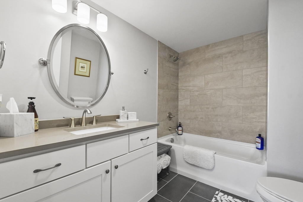 635 Old Post Road, Unit 108 Sharon, MA 02067 - Photo 13 of 42 a bathroom with a toilet a sink and mirror