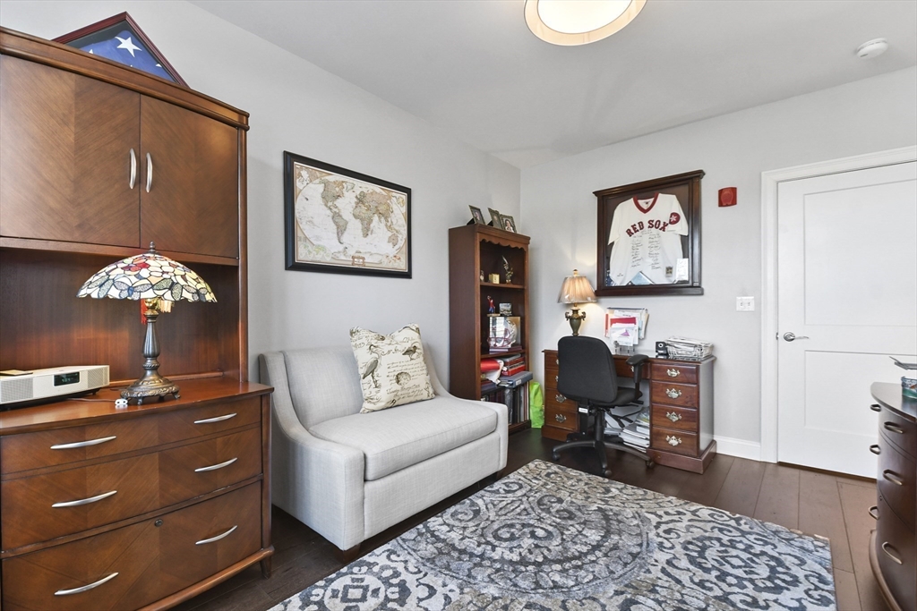 635 Old Post Road, Unit 108 Sharon, MA 02067 - Photo 17 of 42 a living room with furniture and a fireplace
