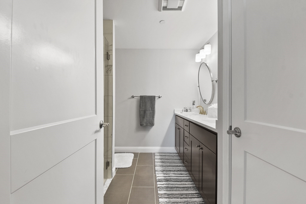 635 Old Post Road, Unit 108 Sharon, MA 02067 - Photo 29 of 42 a bathroom with a sink and mirror