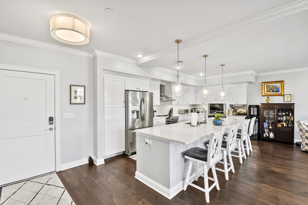 635 Old Post Road, Unit 108 Sharon, MA 02067 - Photo 3 of 42 a large kitchen with a table and chairs