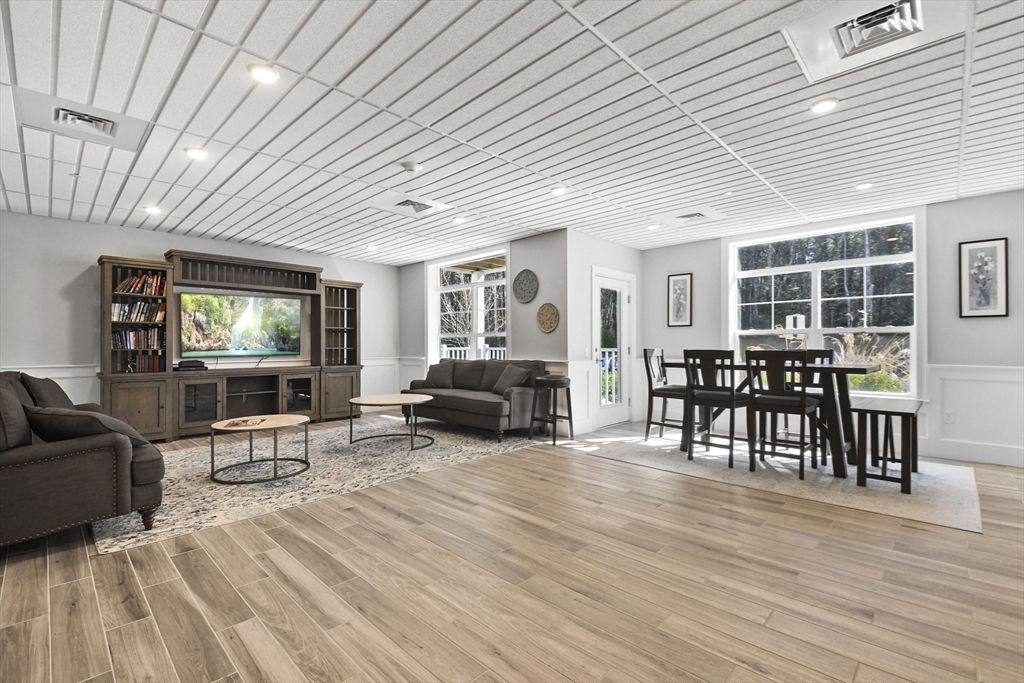 635 Old Post Road, Unit 108 Sharon, MA 02067 - Photo 33 of 42 a living room with furniture and a flat screen tv