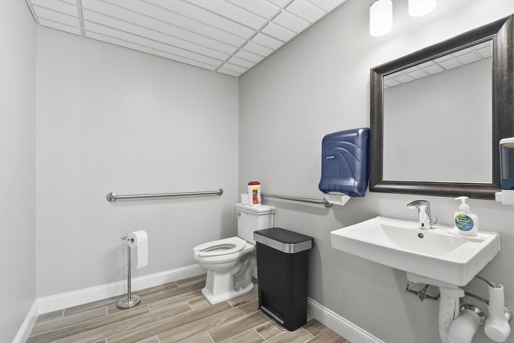 635 Old Post Road, Unit 108 Sharon, MA 02067 - Photo 34 of 42 a bathroom with a toilet sink and mirror