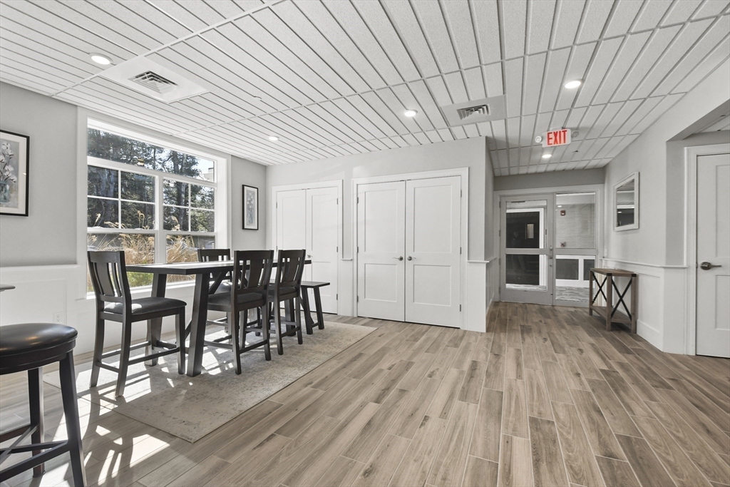 635 Old Post Road, Unit 108 Sharon, MA 02067 - Photo 37 of 42 a view of a dining room with furniture window and wooden floor