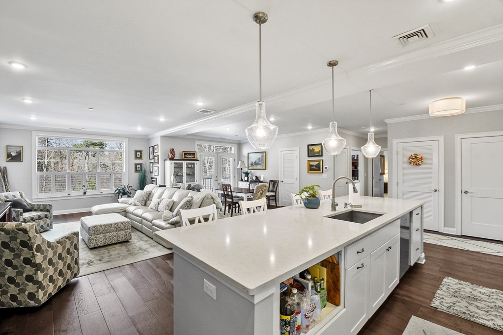 635 Old Post Road, Unit 108 Sharon, MA 02067 - Photo 5 of 42 a large white kitchen with a large window and stainless steel appliances