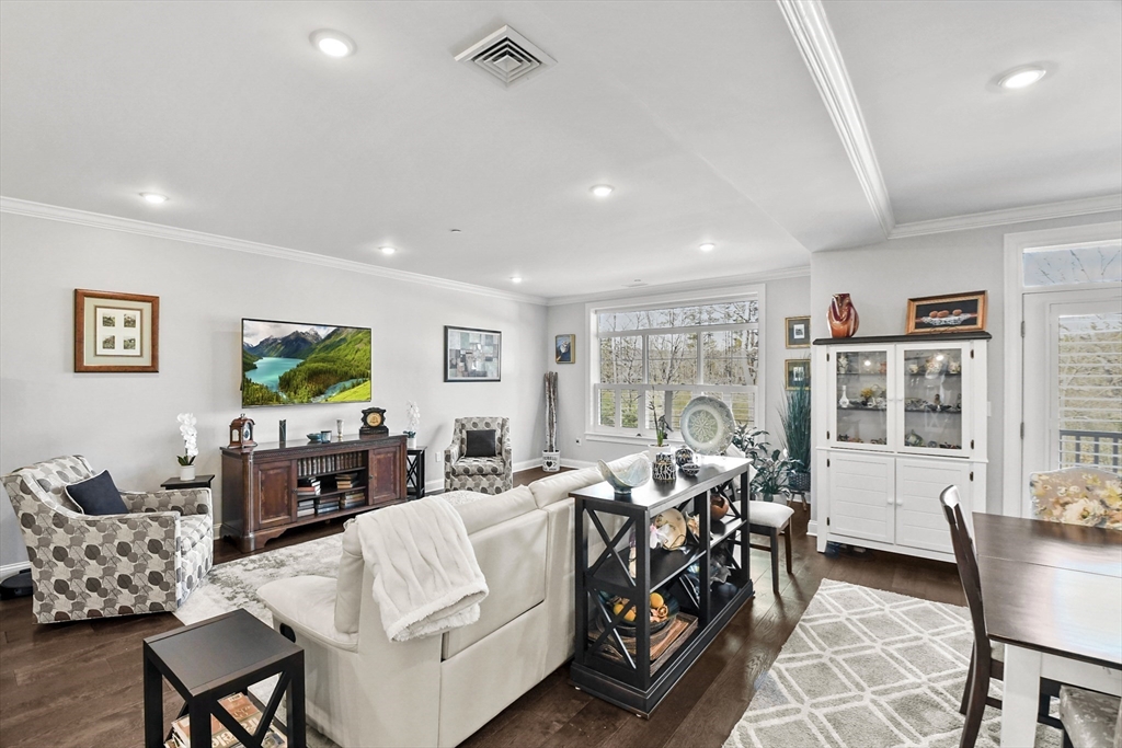 635 Old Post Road, Unit 108 Sharon, MA 02067 - Photo 8 of 42 a living room with furniture and a flat screen tv