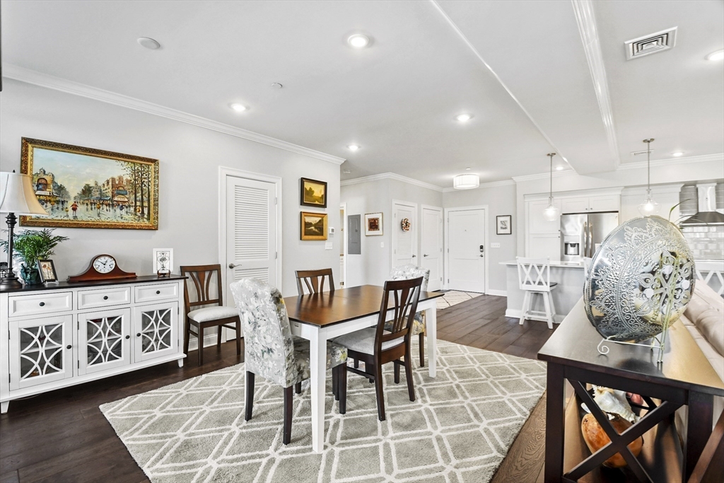 635 Old Post Road, Unit 108 Sharon, MA 02067 - Photo 10 of 42 a view of a dining room with furniture and wooden floor