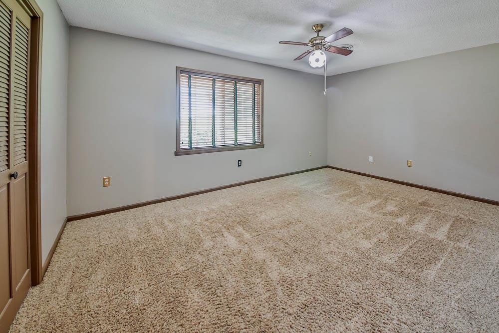 272 Brammer Road Covington, TN 38019 - Photo 17 of 31 an empty room with windows and ceiling fan