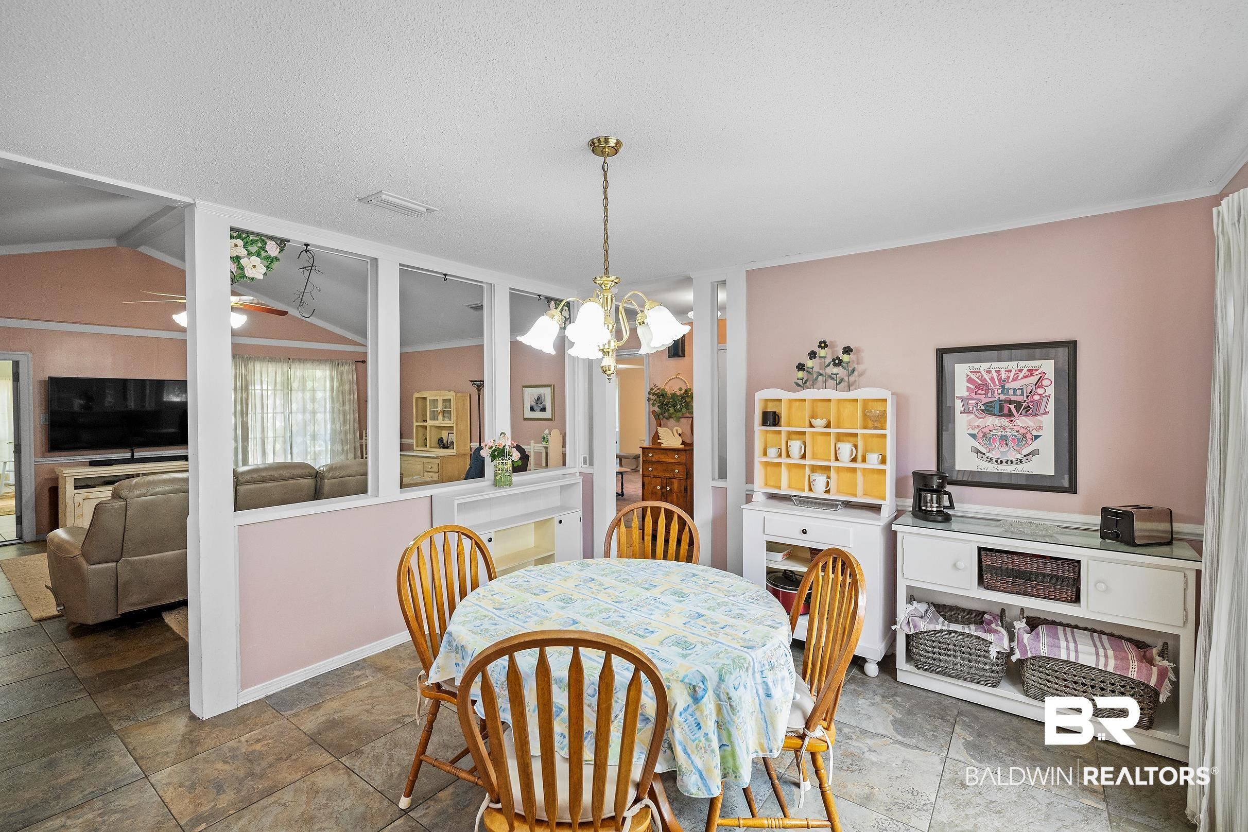 4026 Kingsrow Row Mobile, AL 36619 - Photo 13 of 51 Dining room with hanging lights, stone finish flooring, and a ceiling fan