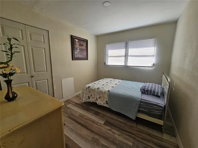 a bedroom with a bed and a dresser